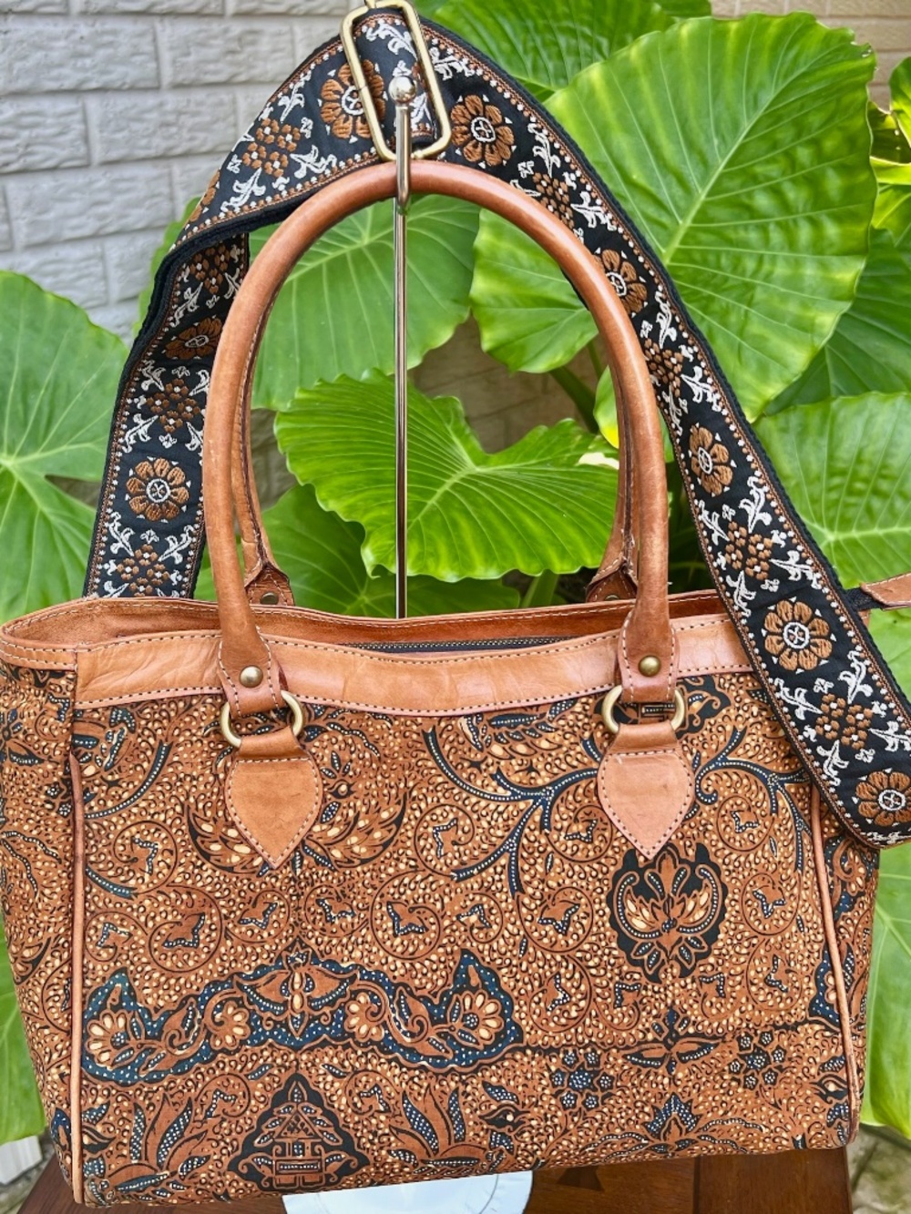 Handcrafted leather satchel featuring traditional Indonesian batik patterns